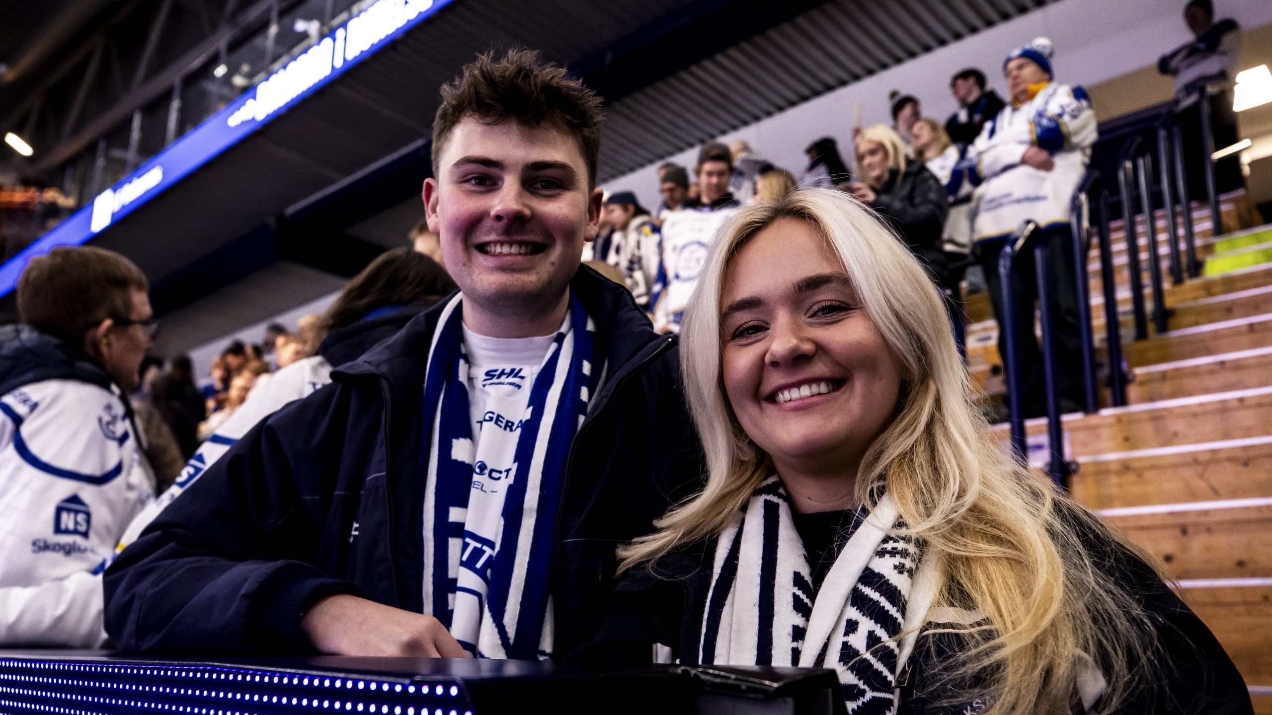 Två personer ler mot kameran på Leksands IF:s läktare.