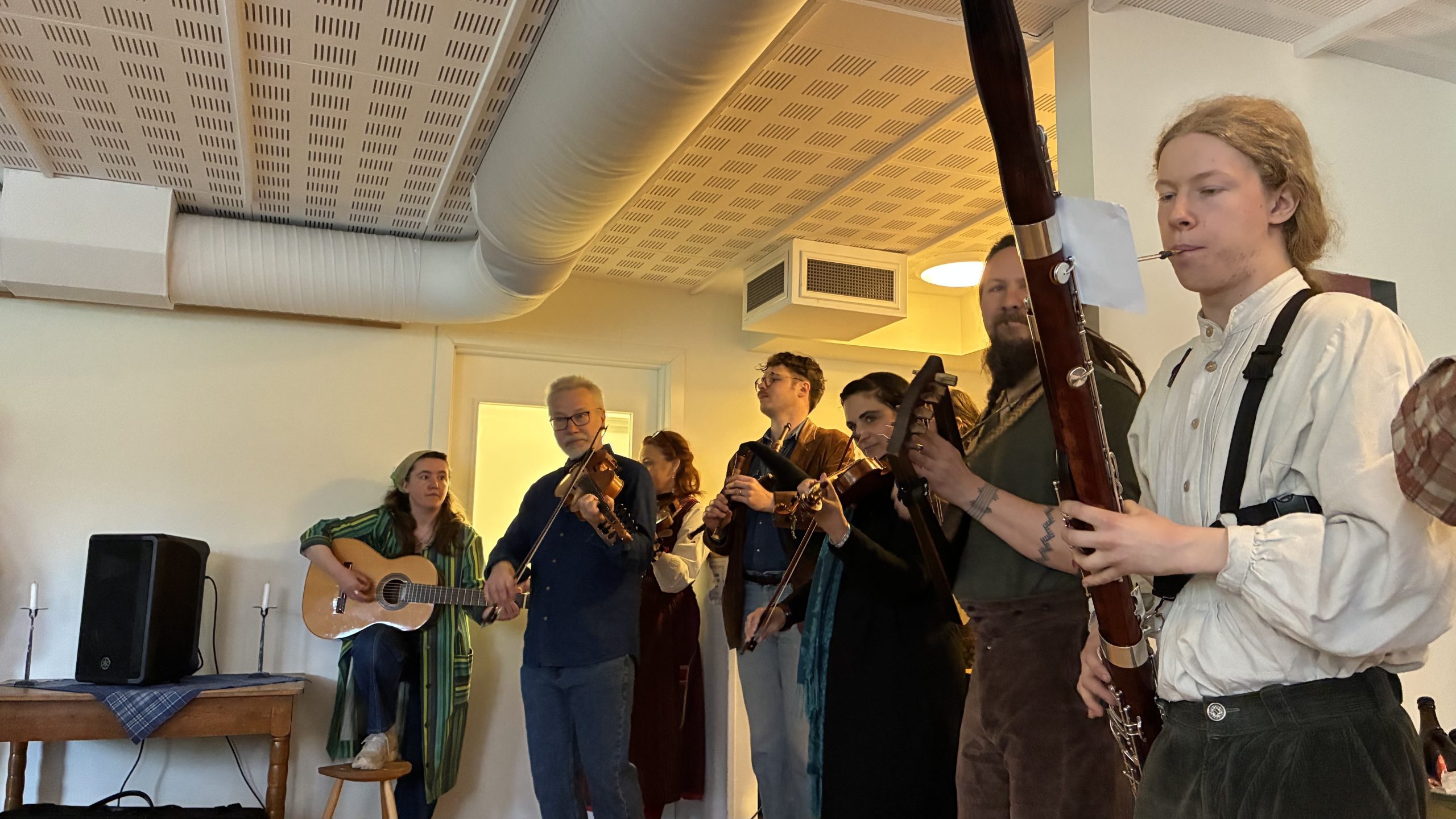 Spelmanslag med en variation av instrument som fioler, säckpipor och fagotter.